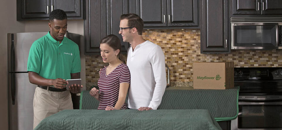 Couple In Kitchen With Mover